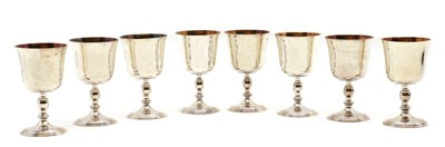 Lot 1 - A set of eight silver and silver-gilt goblets