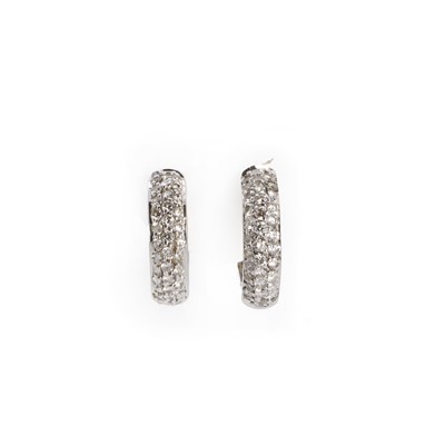 Lot 1088 - A pair of white gold, diamond set 'huggy' style hinged 'D' section hoop earrings