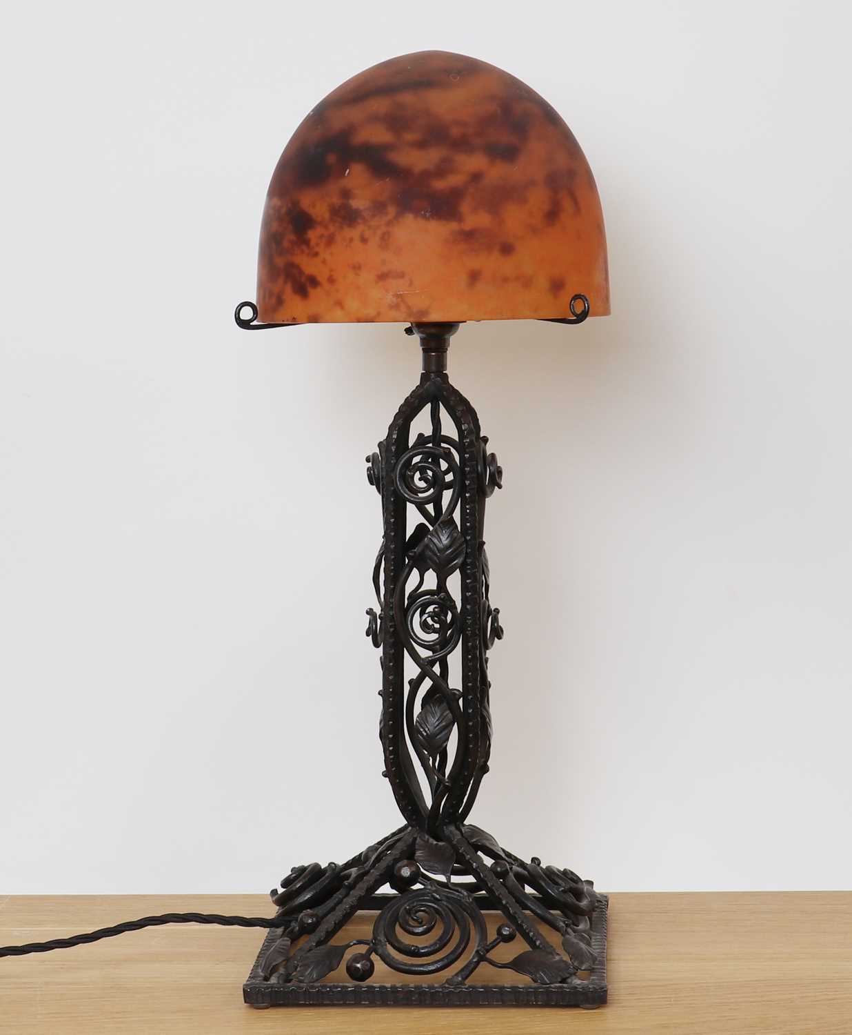 Lot 260 - A Daum glass and wrought iron table lamp