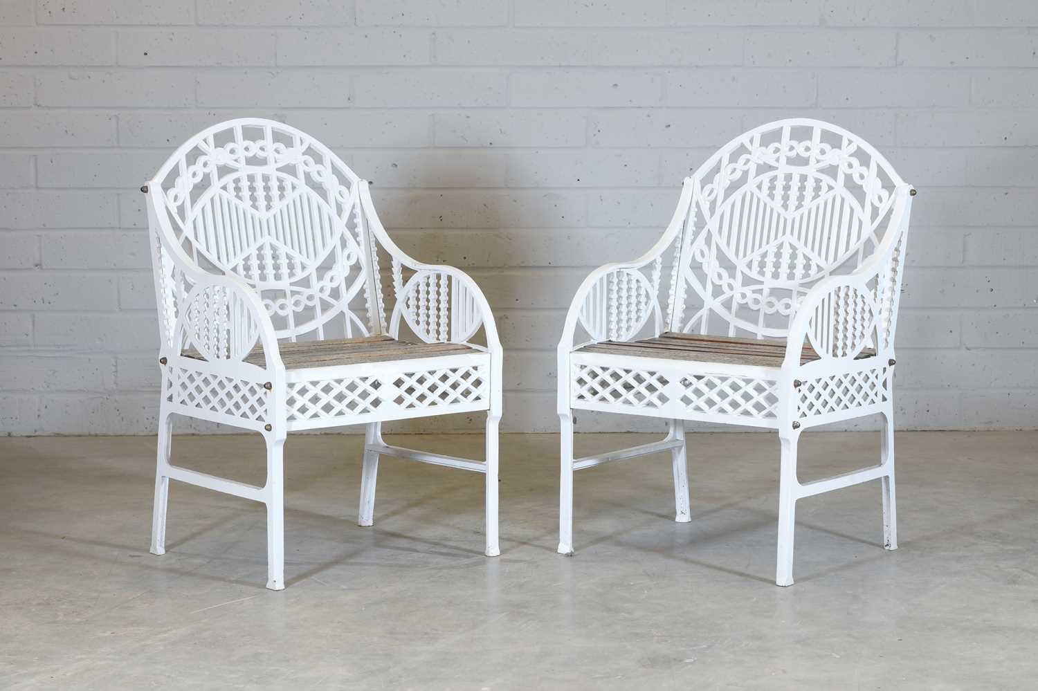 Lot 181 - A pair of cast iron garden chairs