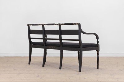 Lot 10 - A Regency-style ebonised and parcel-gilt chair-back settee
