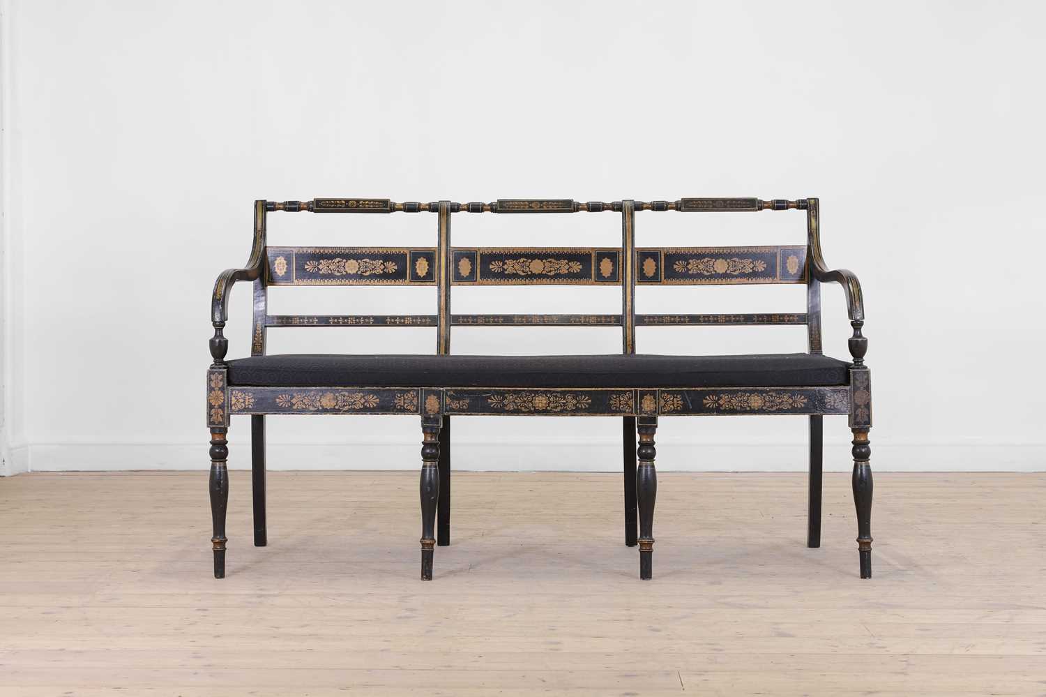Lot 10 - A Regency-style ebonised and parcel-gilt chair-back settee