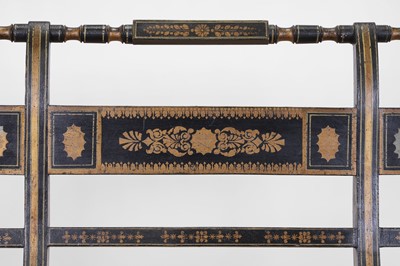 Lot 10 - A Regency-style ebonised and parcel-gilt chair-back settee