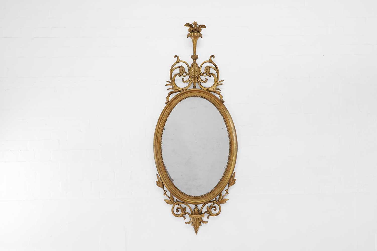 Lot 6 - A George III-style giltwood and gesso oval mirror