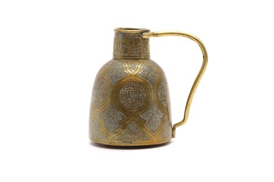 Lot 56 - An Islamic brass jug
