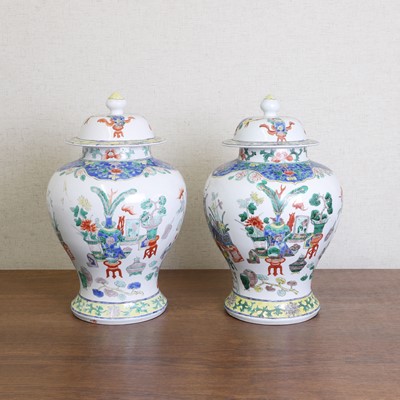 Lot 175 - A pair of Chinese famille verte vases and covers