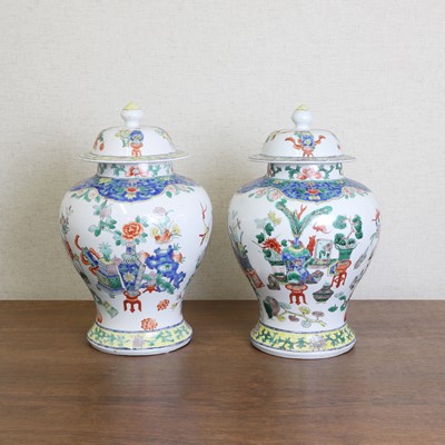 Lot 100 - A pair of Chinese famille verte vases and covers