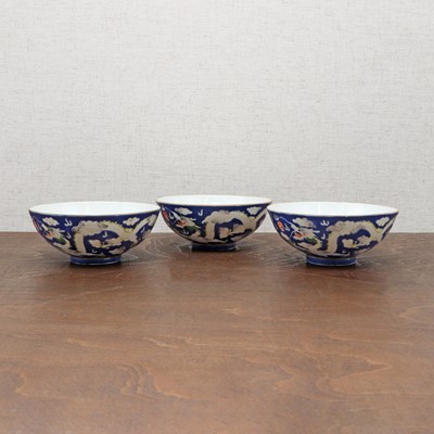 Lot 74 - Three Chinese blue-ground white-enamelled bowls