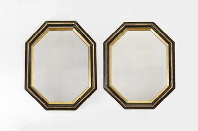 Lot 192 - A pair of ebonised and giltwood mirrors