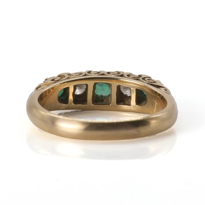 Lot 86 - A gold five stone emerald and diamond ring