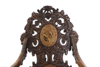 Lot 369 - A carved Black Forest elbow chair