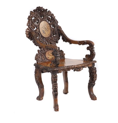 Lot 369 - A carved Black Forest elbow chair