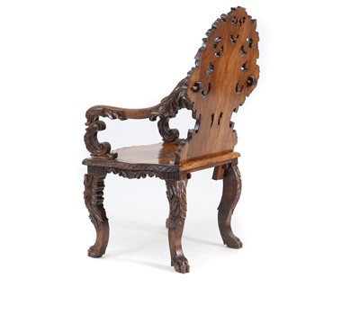 Lot 369 - A carved Black Forest elbow chair