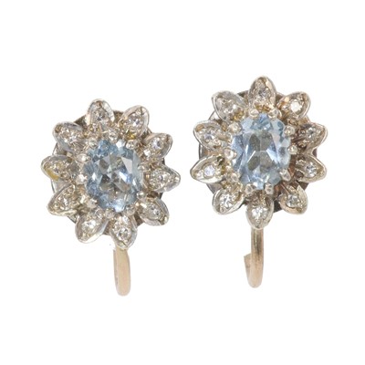 Lot 90 - A pair of gold aquamarine and diamond set cluster screw back earrings