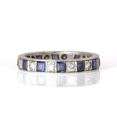 Lot 28 - A diamond and sapphire eternity ring