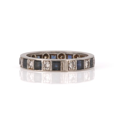 Lot 28 - A diamond and sapphire eternity ring