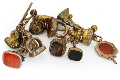 Lot 263 - A rose gold bracelet suspending assorted fob seals and watch keys