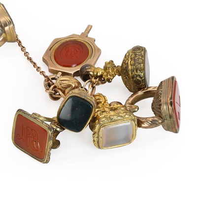 Lot 263 - A rose gold bracelet suspending assorted fob seals and watch keys