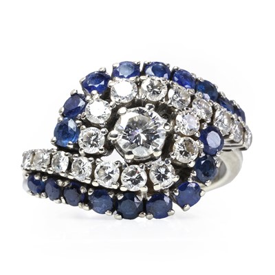 Lot 85 - A white gold sapphire and diamond crossover ring