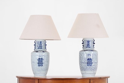 Lot 67 - A pair of blue and white porcelain table lamps