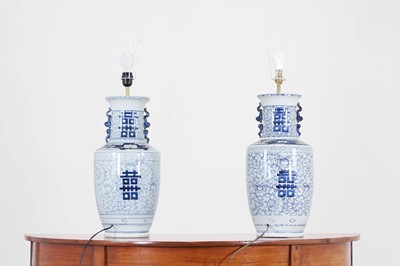 Lot 67 - A pair of blue and white porcelain table lamps