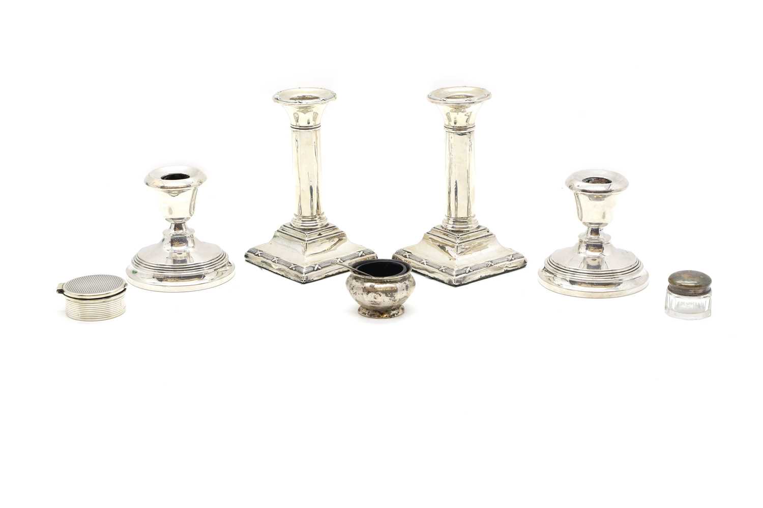 Lot 37 - A pair of silver dwarf candlesticks