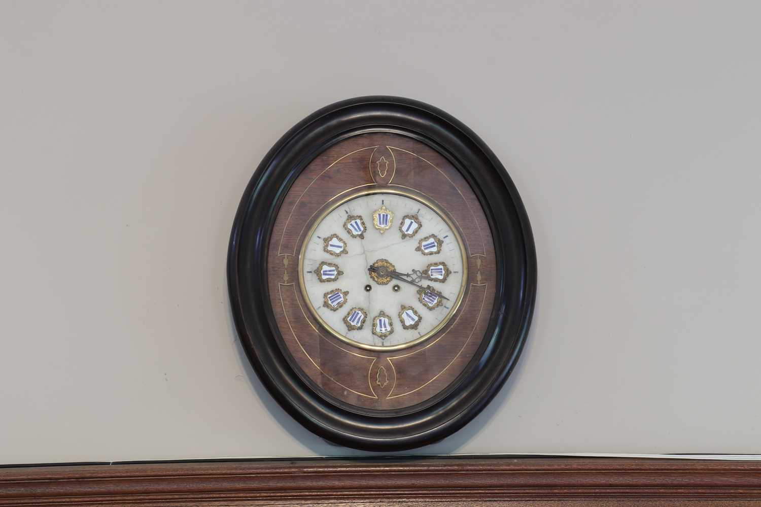 Lot 50 - A French eight-day striking wall clock