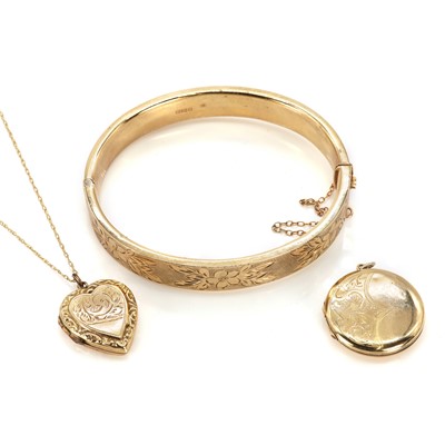 Lot 209 - A 9ct gold bangle and two back and front lockets