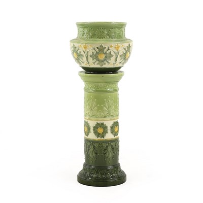 Lot 131 - A glazed pottery jardinière and stand