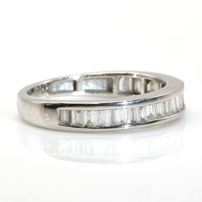 Lot 41 - A platinum baguette cut diamond half eternity ring, by Rhapsody