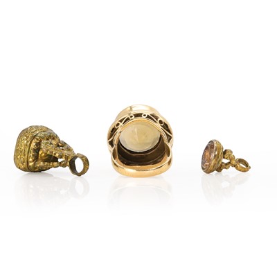 Lot 241 - A 9ct gold smoky quartz ring and two base metal fobs