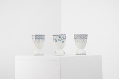 Lot 393 - Three glazed earthenware egg cups