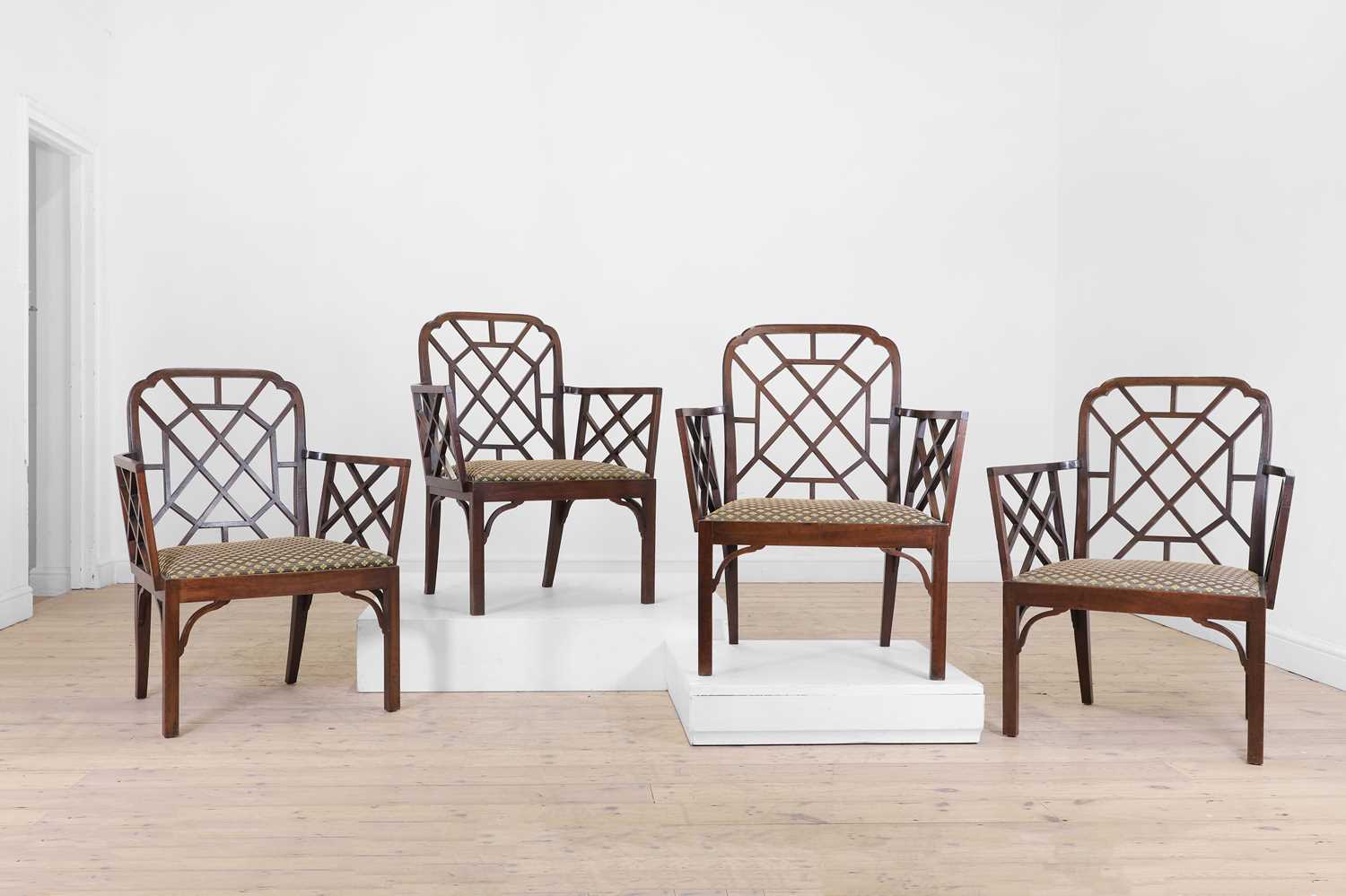 Lot 66 - A set of four George III-style mahogany 'cockpen' elbow chairs