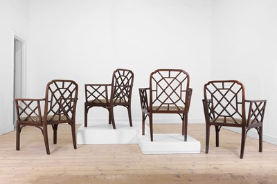 Lot 66 - A set of four George III-style mahogany 'cockpen' elbow chairs