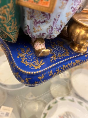 Lot 54 - A pair of porcelain figural scent holders