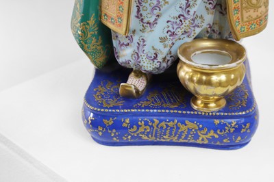 Lot 54 - A pair of porcelain figural scent holders