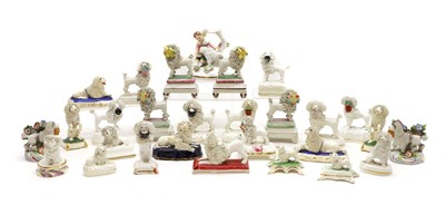 Lot 111 - A collection of Staffordshire pottery poodles
