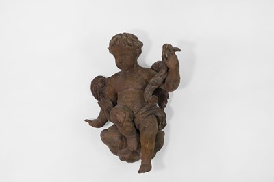 Lot 304 - A baroque carved and painted pine putto