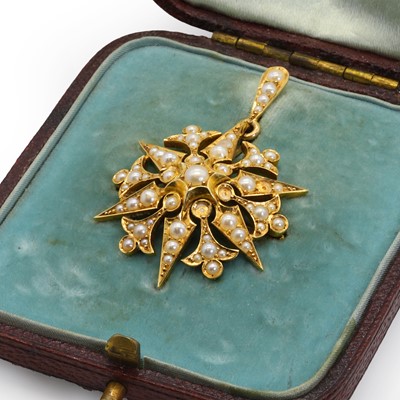 Lot 22 - An Edwardian gold split pearl starburst brooch
