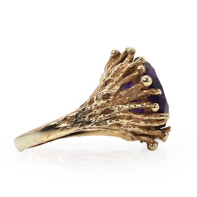 Lot 50 - An abstract design amethyst ring