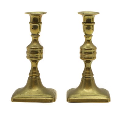 Lot 189 - A pair of George III Golden Jubilee brass ejector candlesticks