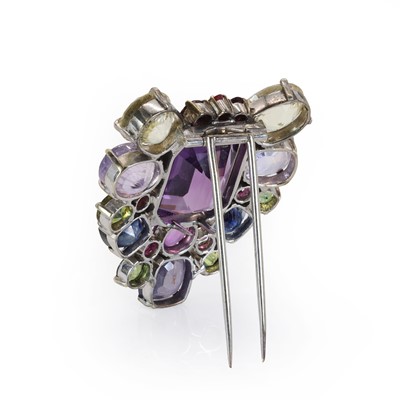 Lot 87 - A varicoloured sapphire and amethyst clip brooch, c.1940-1950
