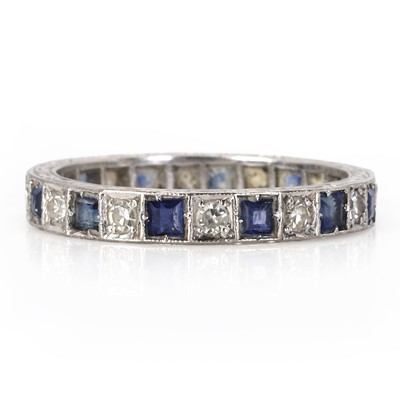 Lot 45 - A sapphire and diamond full eternity ring, c.1950