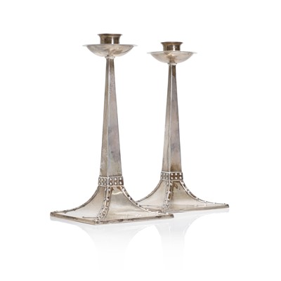 Lot 12 - A pair of Arts and Crafts silver candlesticks