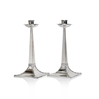 Lot 8 - A pair of Arts and Crafts silver candlesticks