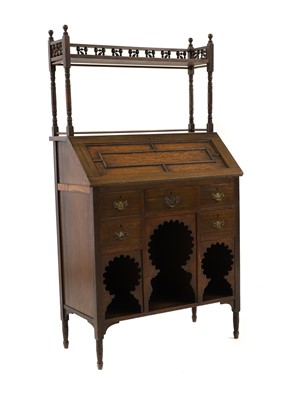 Lot 564 - An Arts and Crafts oak 'Medina'  bureau bookcase