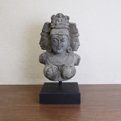 Lot 199 - An Indian grey schist head of the Hindu trimurti