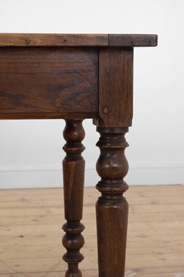 Lot 64 - A Victorian oak kitchen table