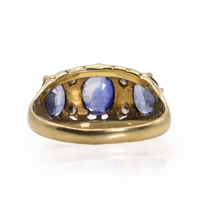 Lot 116 - A gold three stone sapphire and diamond ring