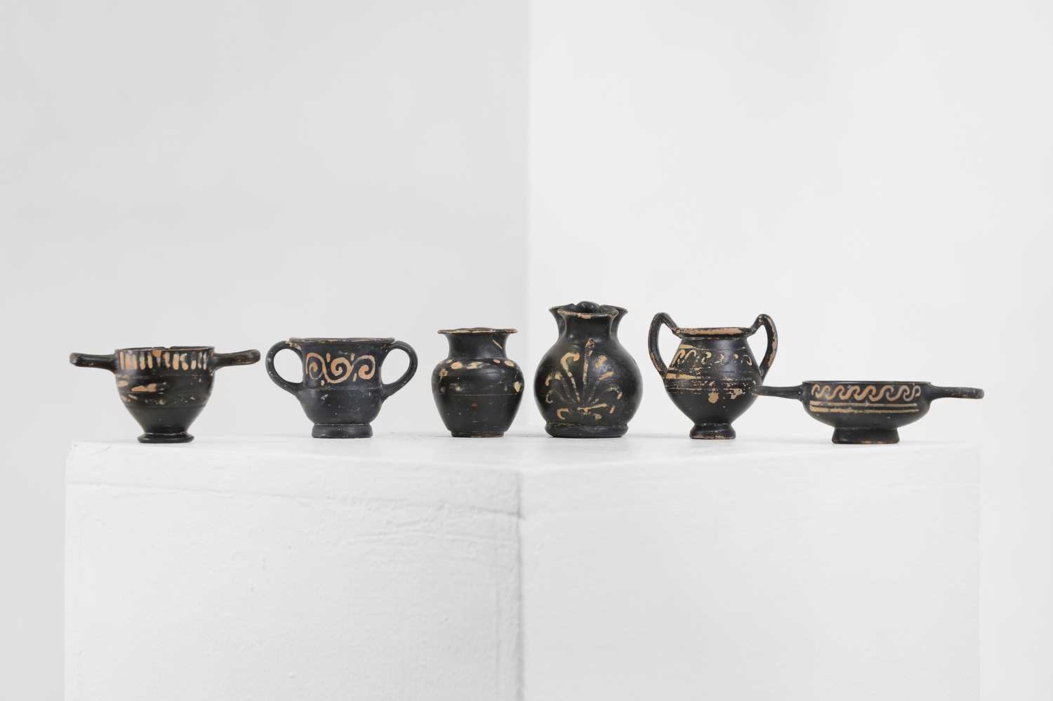 Lot 102 - A group of six Xenon ware miniature pottery vessels